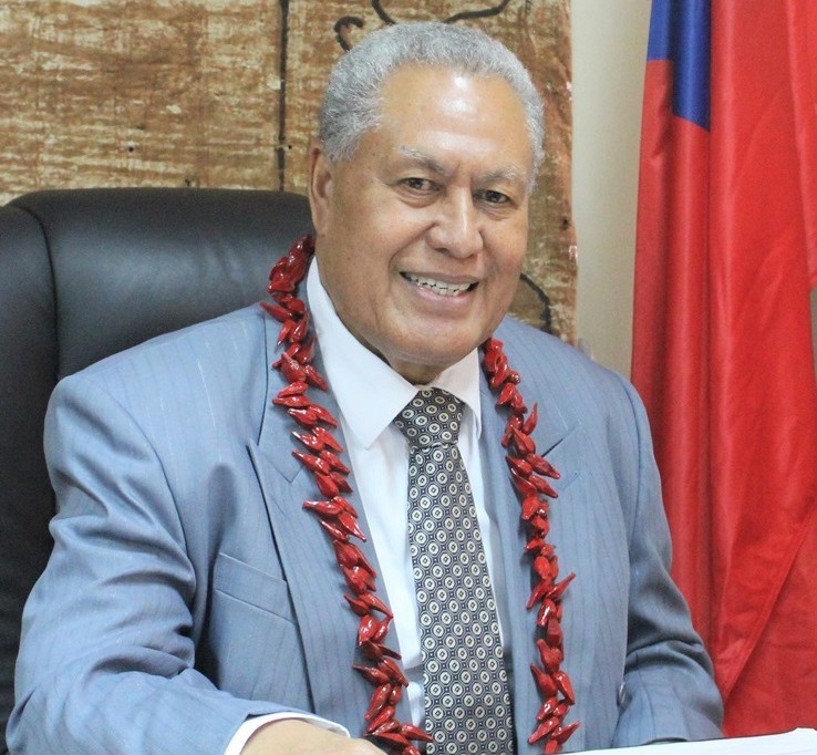 The Head of State official and smiling to camera