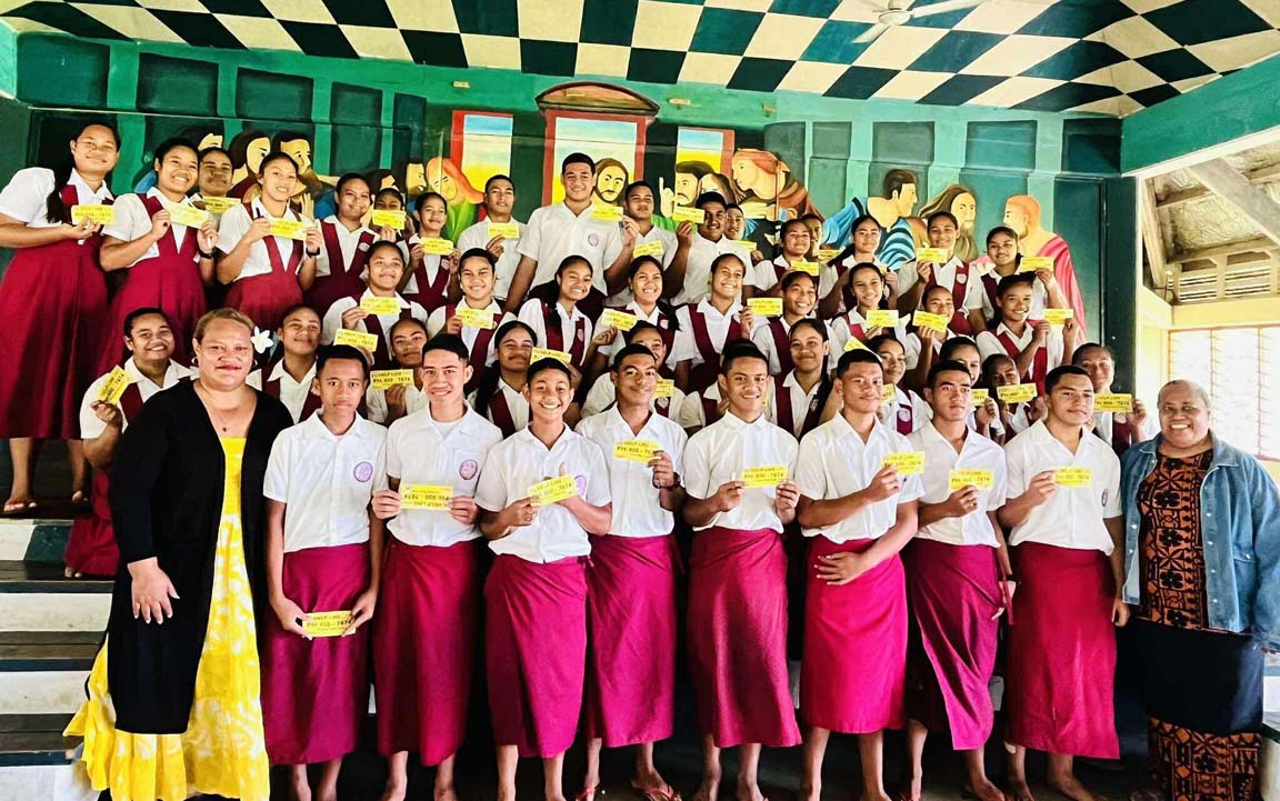 school students holding up yellow papers
